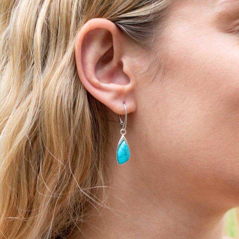 silver and turquoise tear drop earrings on model