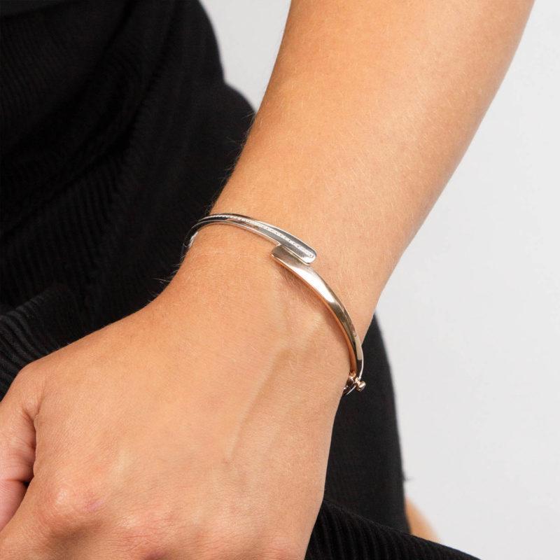 Lady Wearing a Silver and Rose Gold Bangle by Fiorelli