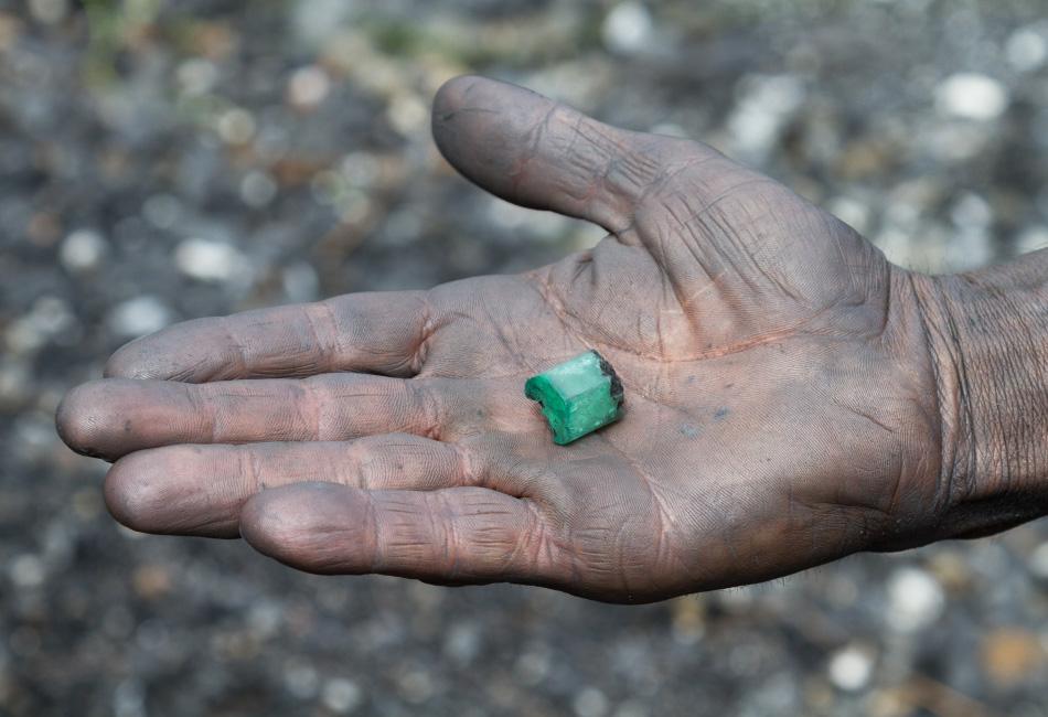 Rough emerald in miners hand