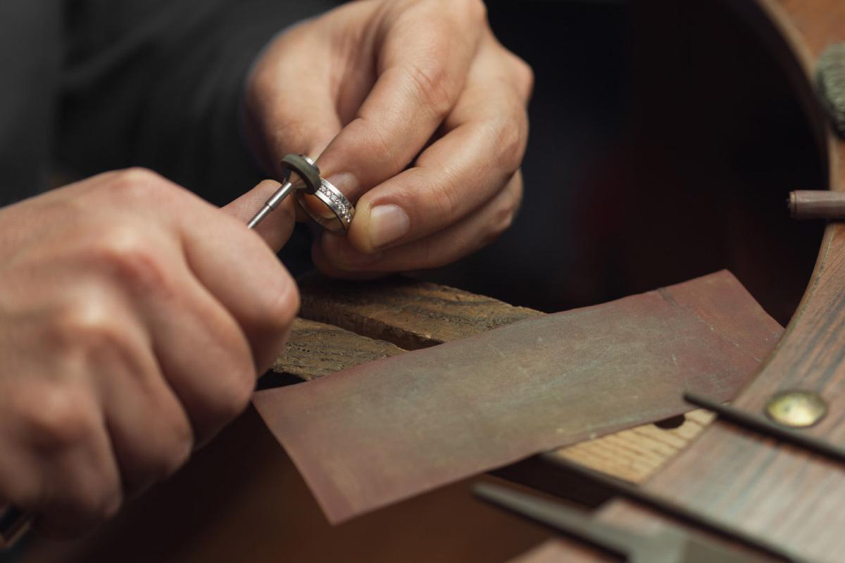 goldsmith polishing a diamond ring