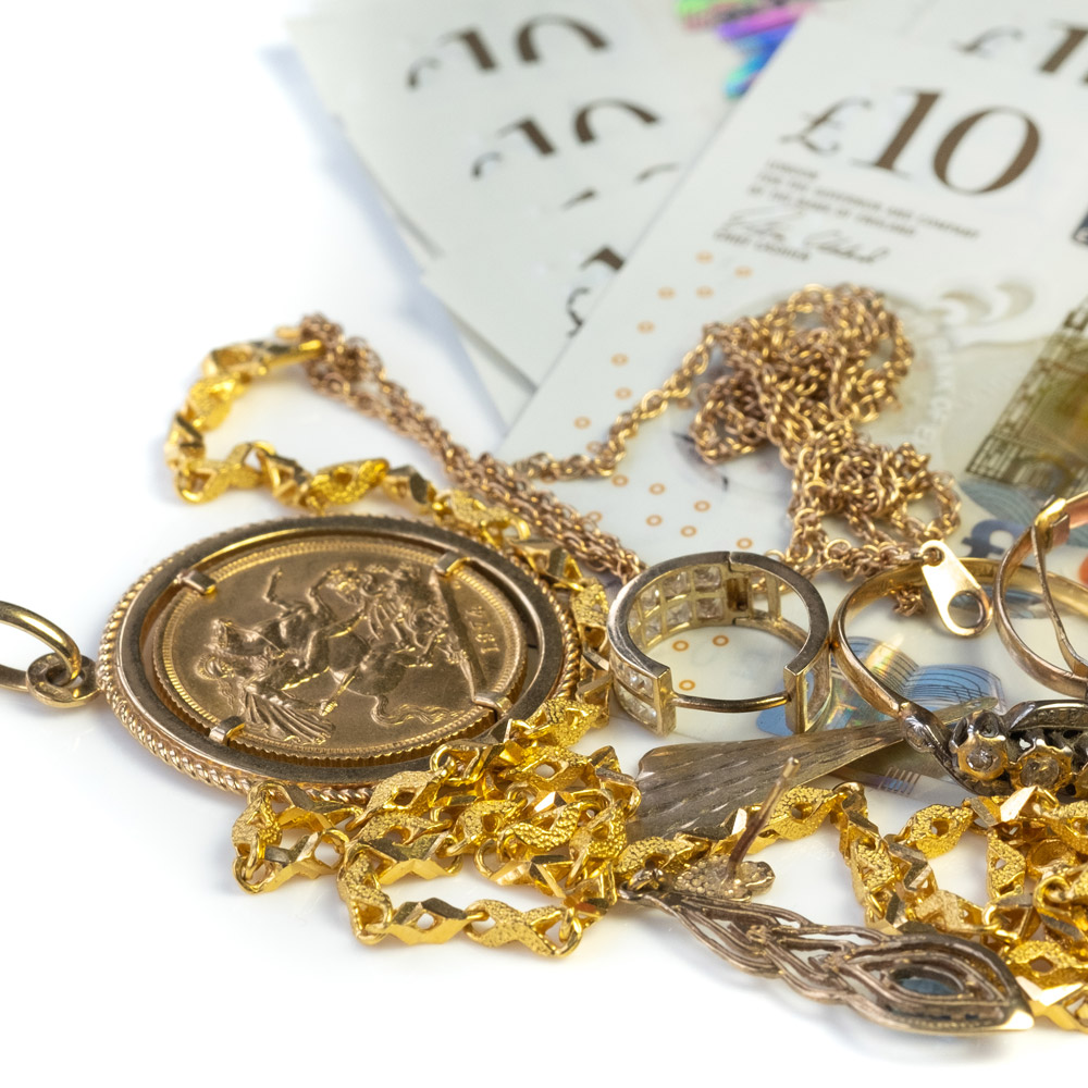 gold jewellery on pound notes